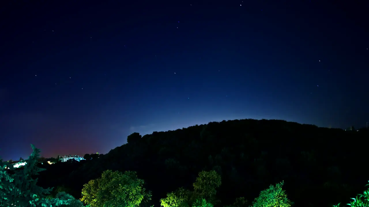 Clouds and stars timelapse on countryside hill