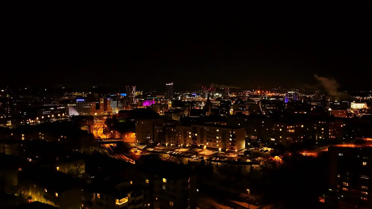 Aerial view toward the illuminated skyline of Tampere city winter evening in Finland