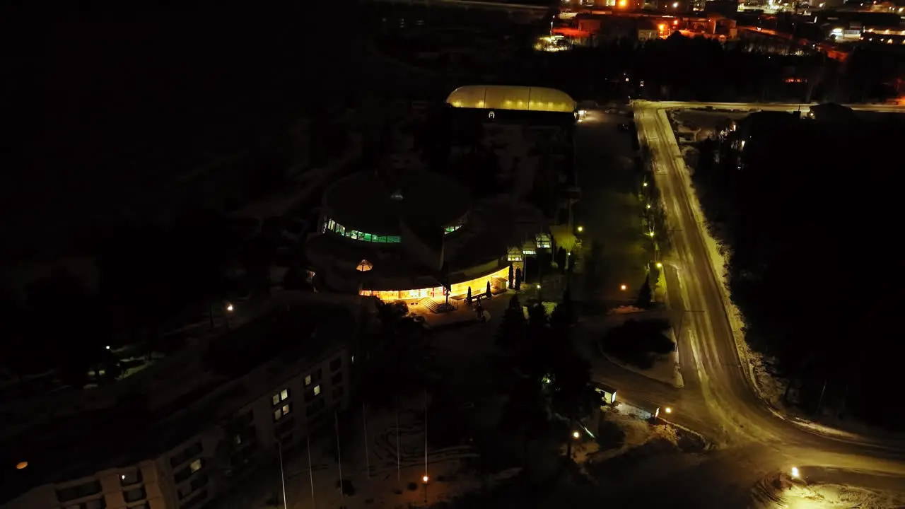 Aerial tilt shot in front of a the Tropiclandia waterpark night in Vaasa Finland