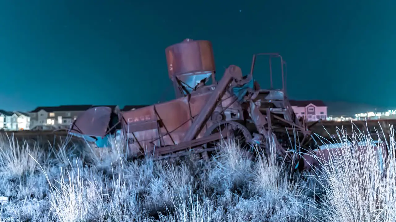 Vintage Chase farm equipment abandoned in a field nighttime motion time lapse