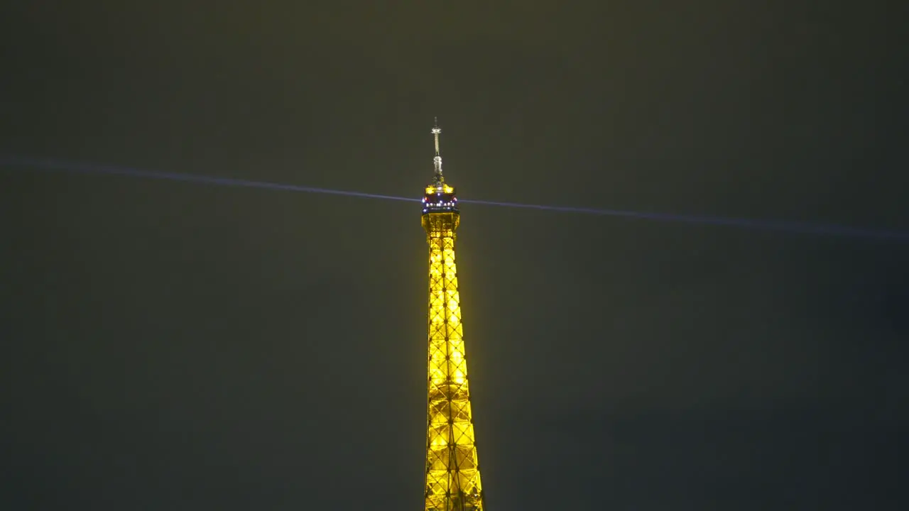 Illuminated cup of the eiffel tower in the dark of night