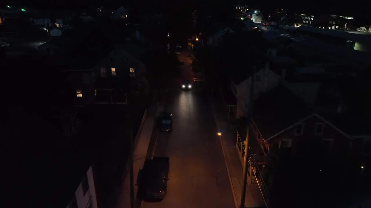 Car driving on dark city alley street