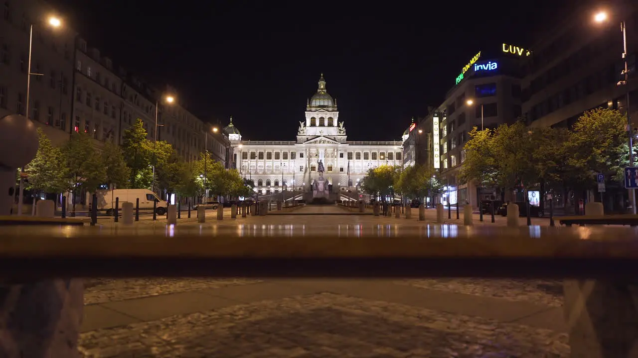 A view of the National museum in Prague Czechia on the empty Wenceslas square in the historical centre illuminated by street lamps during a Covid-19 lockdown no people pedestal shot over a bench