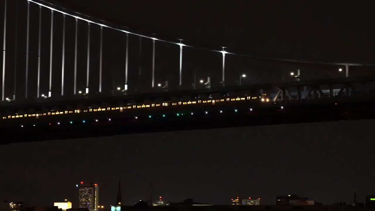 The metro crossing the Ben Franklin Bridge in Philadelphia at night with the lights shining