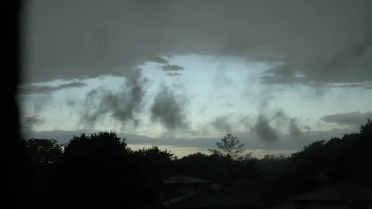 Storm clouds passing quickly over tree tops