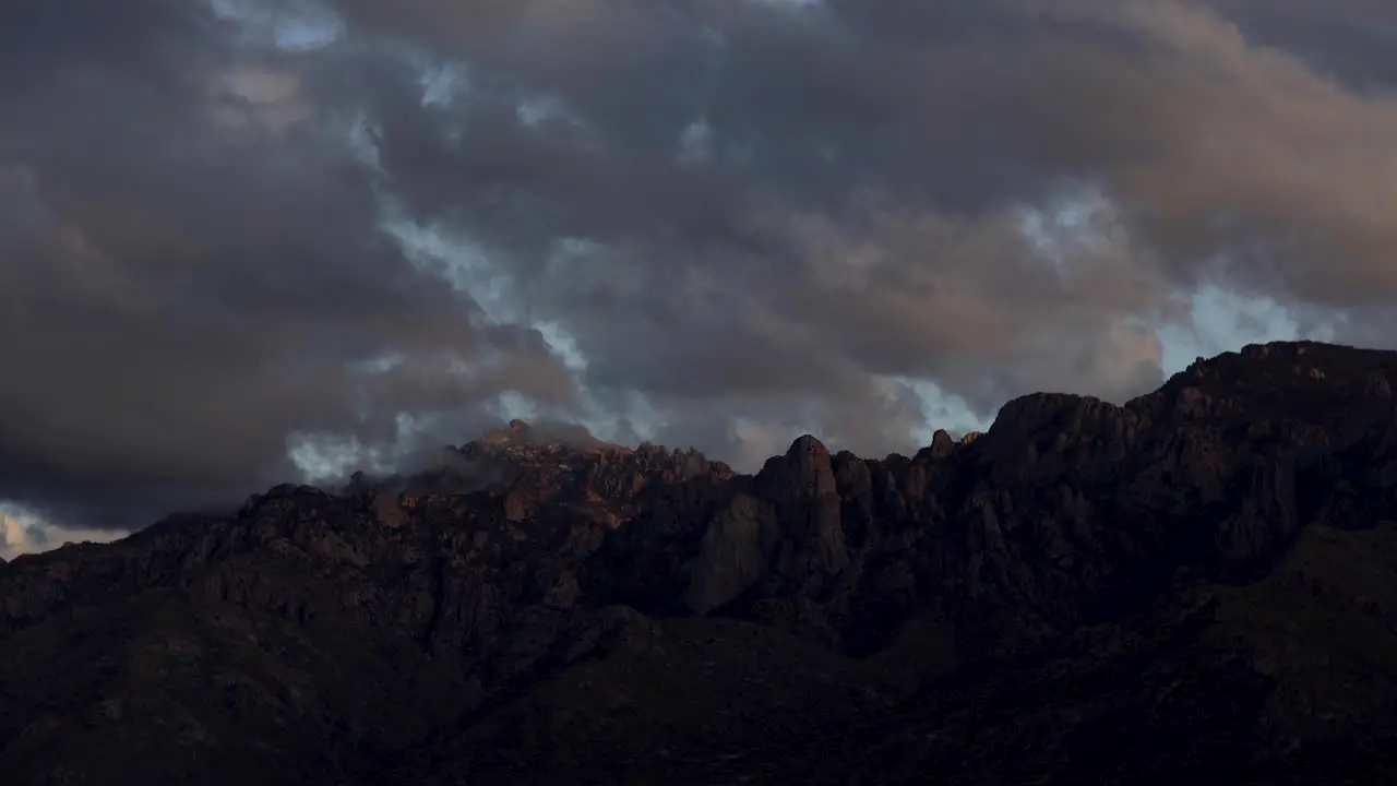 Moody and colorful clouds over Catalina Mountains at Sunset Arizona Dolly Out