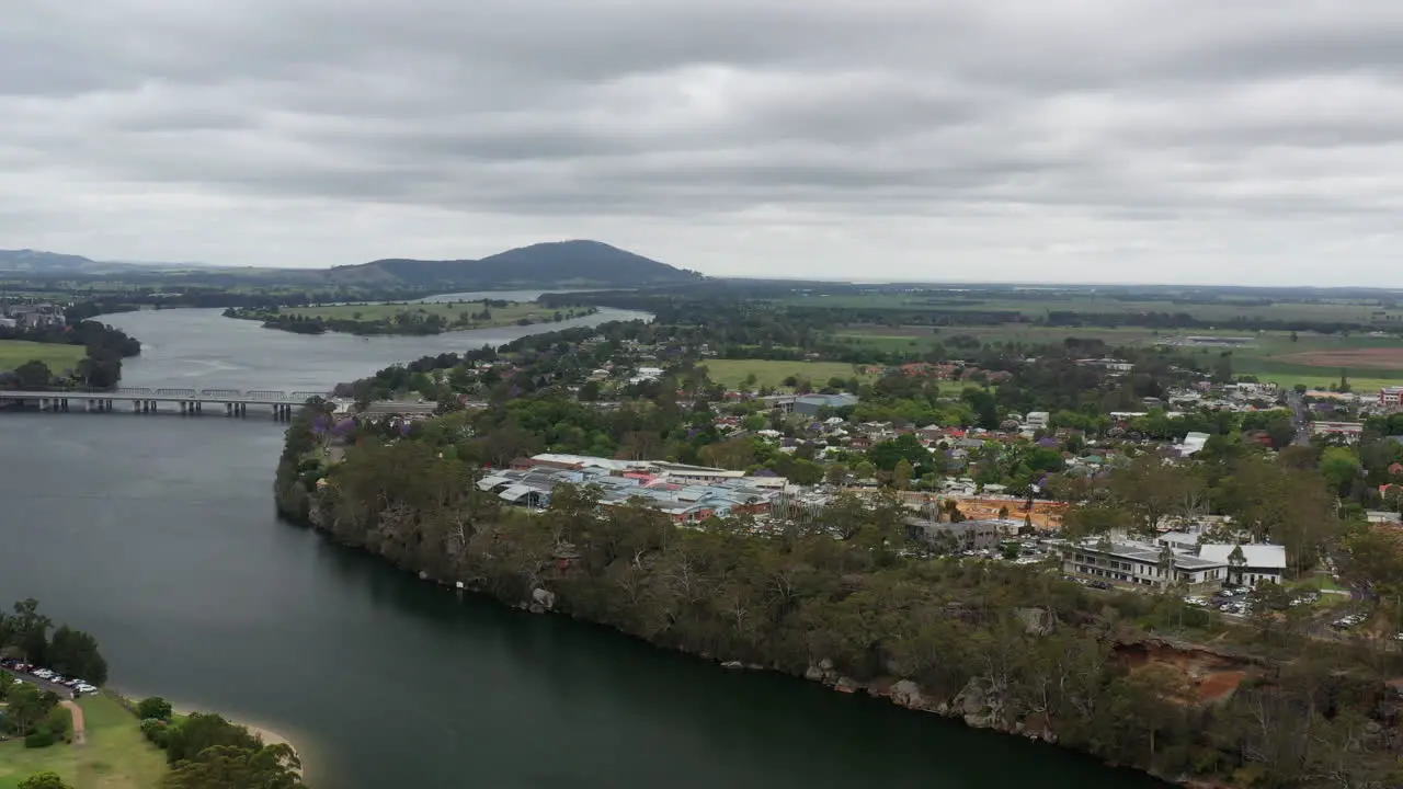 Arial drone shot pulling backwards revealing more of Nowra on a stormy day next to the Shoalhaven river south coast NSW Australia