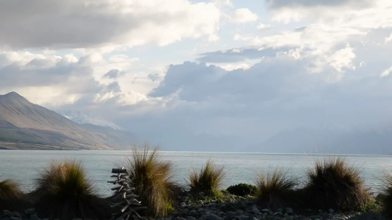 Storm clouds over Lake Pukaki tussock bush in foreground