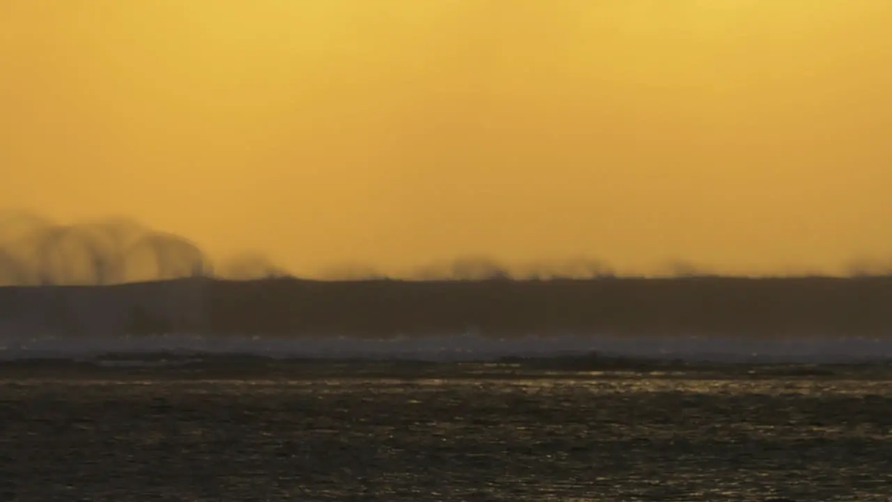 Ocean view with crushing waves at sunset