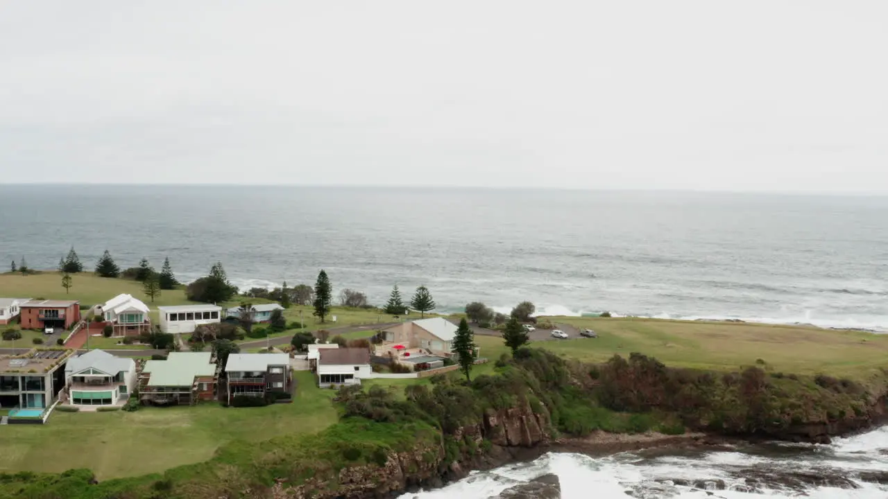 Aerial drone shot flying quickly around Gerroa headland on a stormy day in south coast NSW Australia