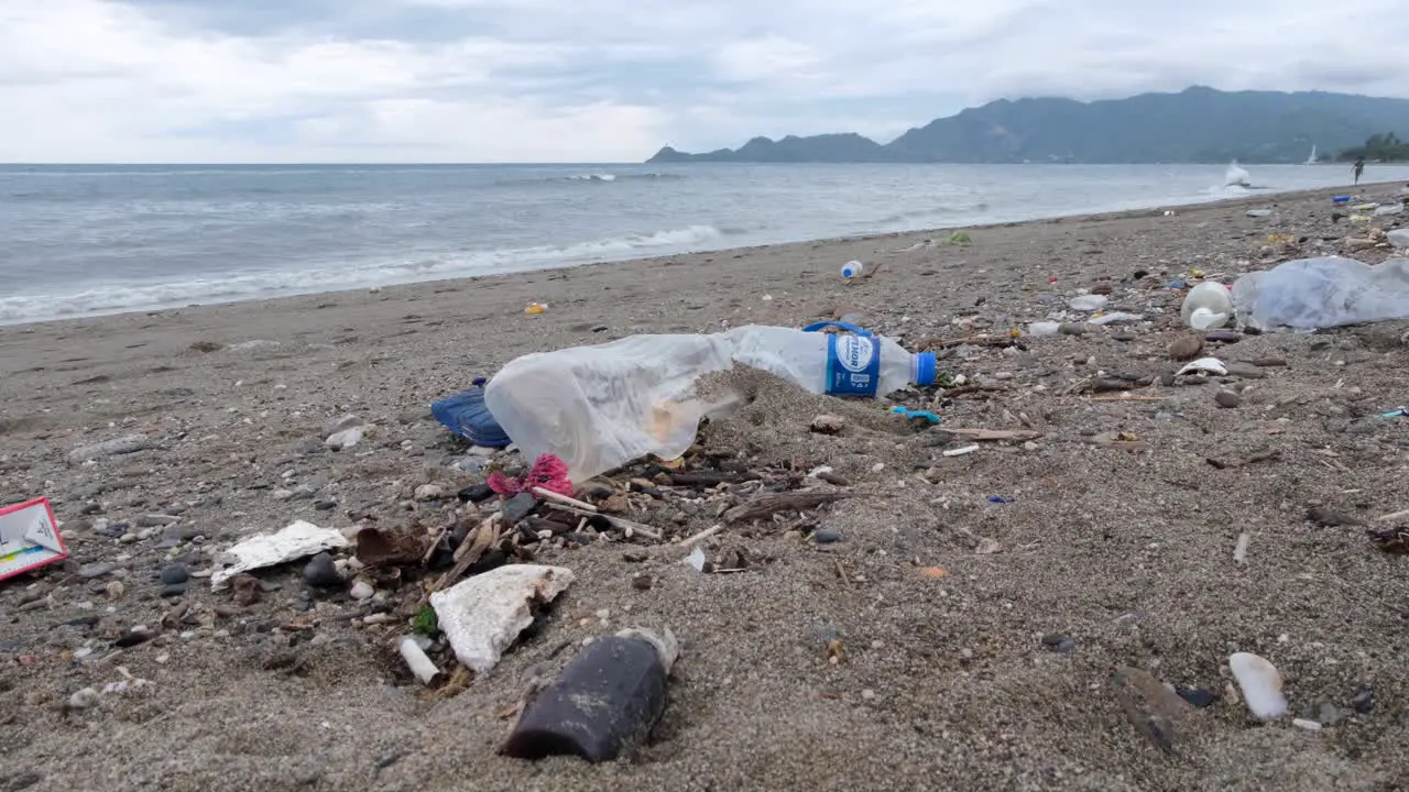 Ocean plastic pollution trash and other rubbish washed ashore onto beach on the tropical island destination in East Timor Southeast Asia