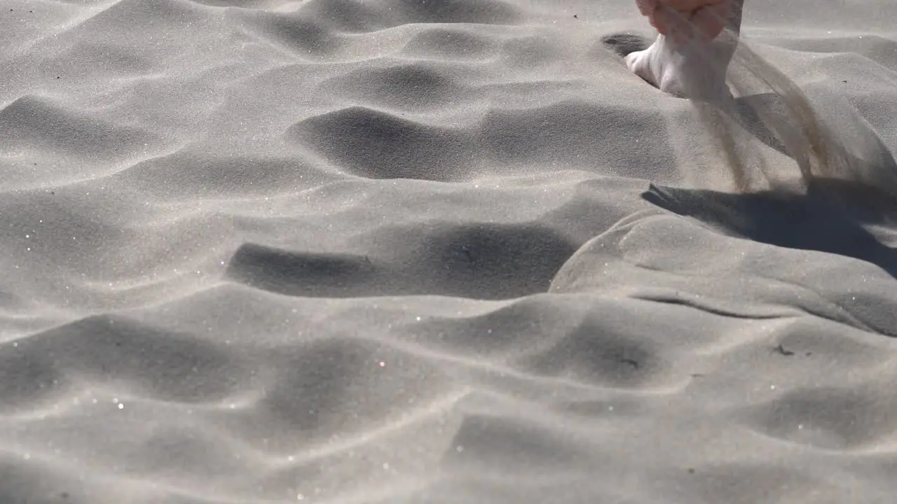 Barefoot walking through soft powdery sand on a sand dune