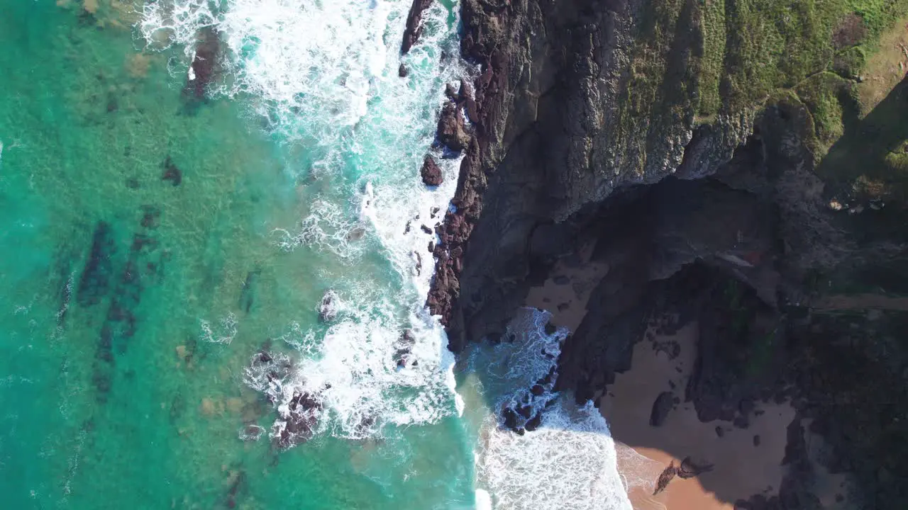 Aerial View Of Wave Hits The Rocks