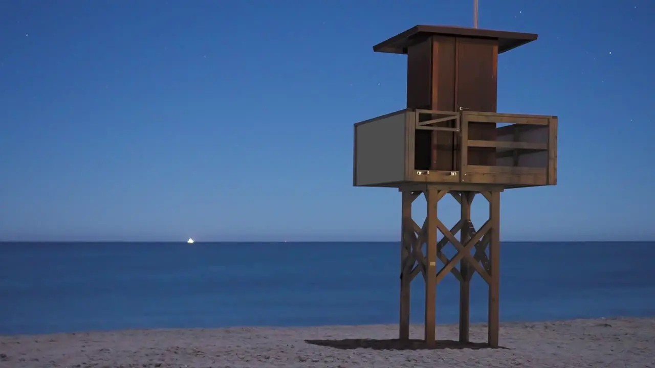 Time lapse of lifeguard tower at night with a clear night sky