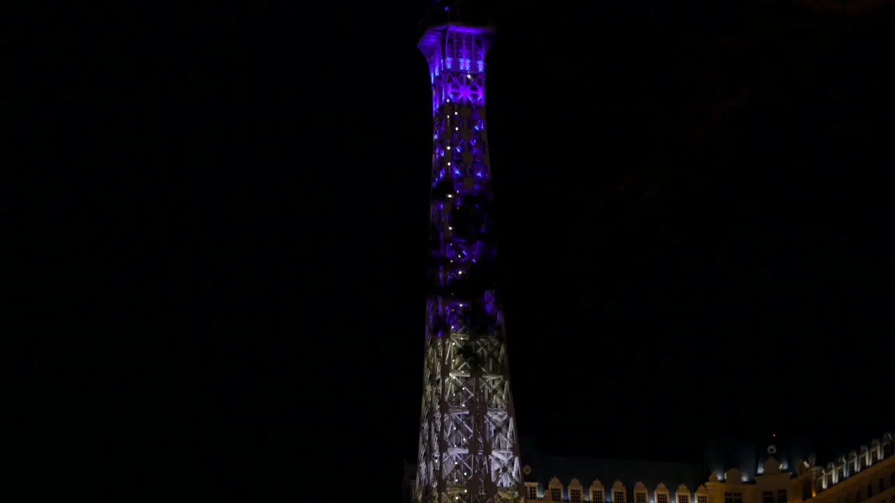 Colorful illuminated Eiffel Tower replica at Paris Las Vegas Hotel Resort Casino at night