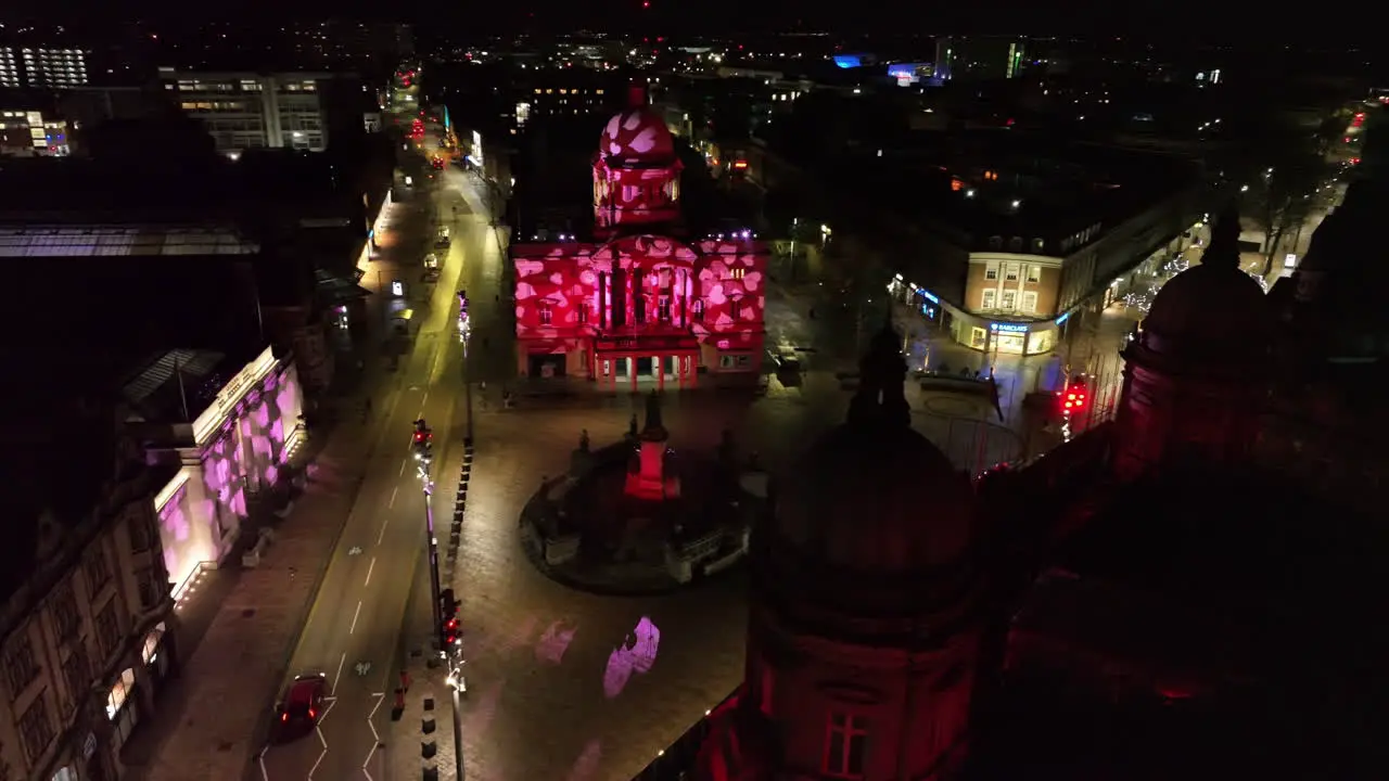 Fly around of Hull's Queen Victoria Square showing night time projections for Valentine's Day on Hull City Hall and Ferens Art Gallery