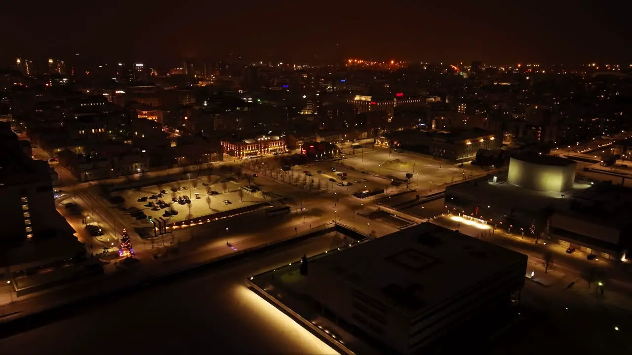 Aerial view toward the illuminated market square of Oulu winter night in Finland