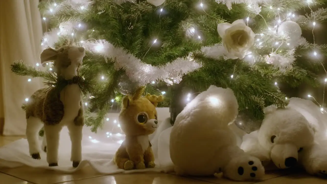 Stuffed toys at the feet of a beautiful Christmas tree