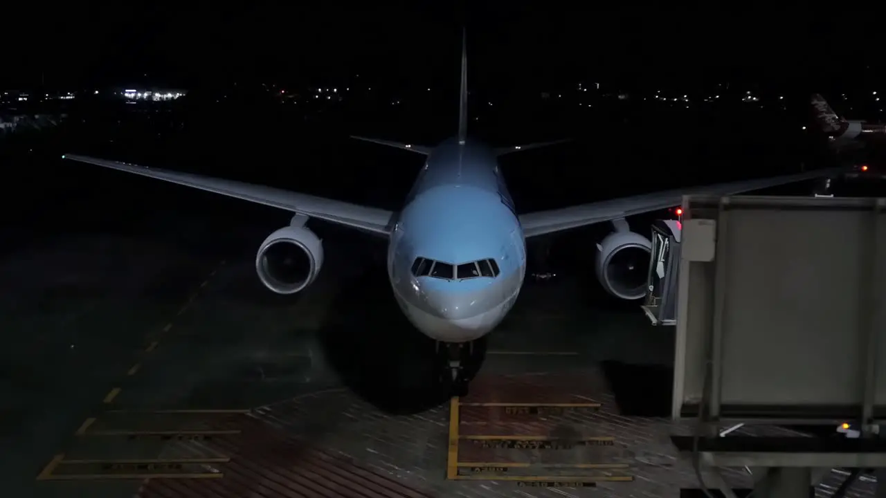 Generic editorial illustrative video of a passenger jet taking its assigned parking slot and tube after landing