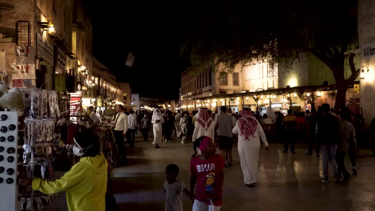 Nighttime view of the central souk in Doha Qatar with local people and tourists shopping in the COVID era