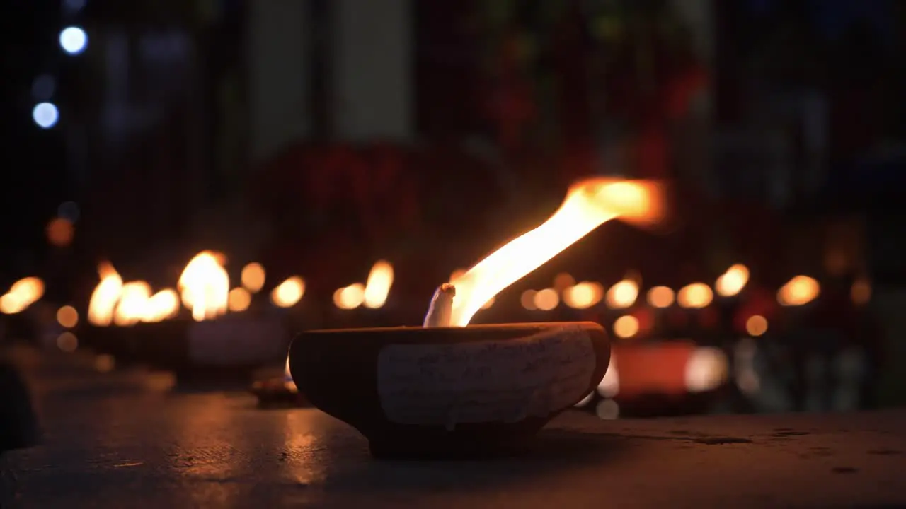 Countless traditional candles burning infront of buddhist temple at night time during Loy Krathong Festival in Chiang Mai Thailand