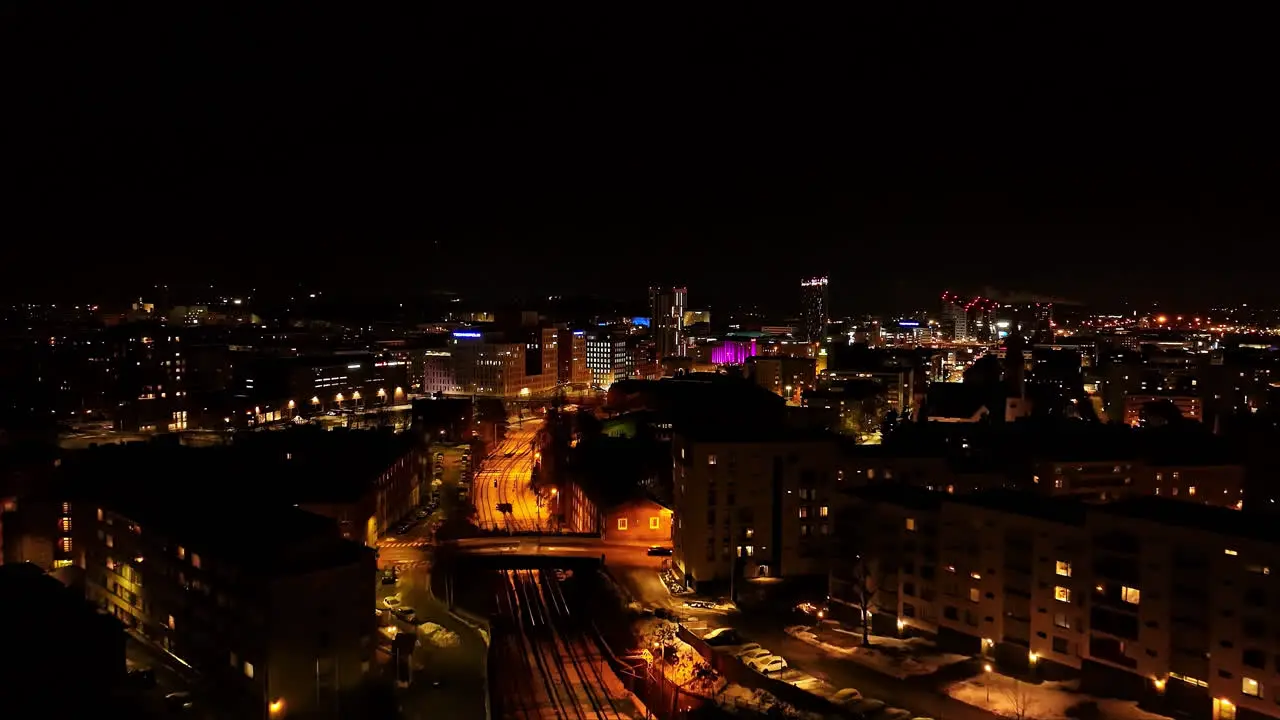 Drone shot approaching downtown Tampere winter night in Pirkanmaa Finland