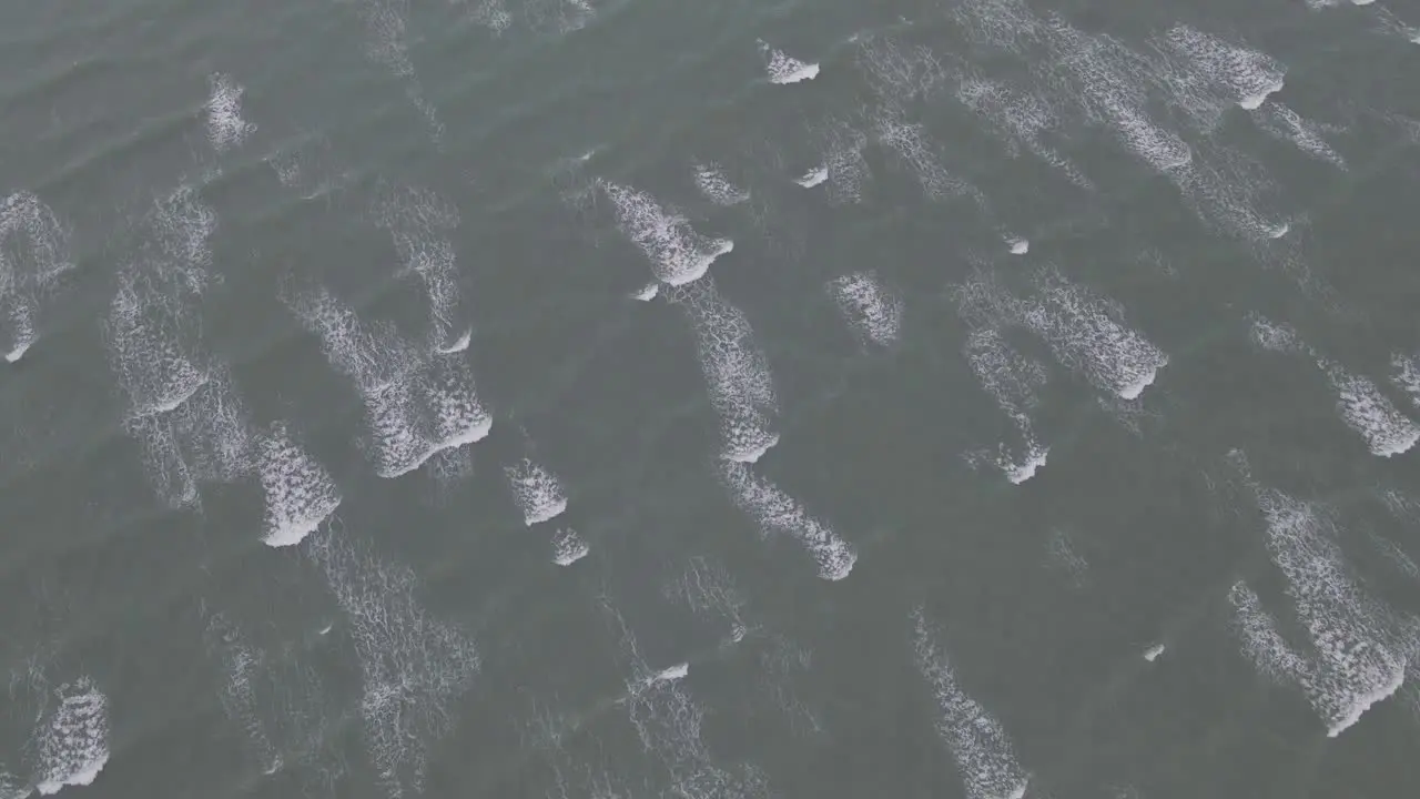 Aerial View Of Small Waves Rolling In The Sea