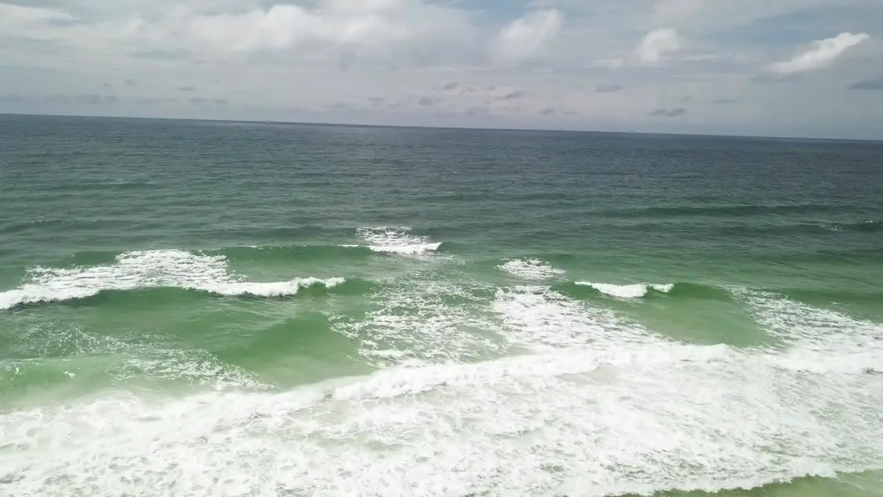 Aerial view of Ocean Splashing Waves Wavy Sea Waters With White Foam drone shot