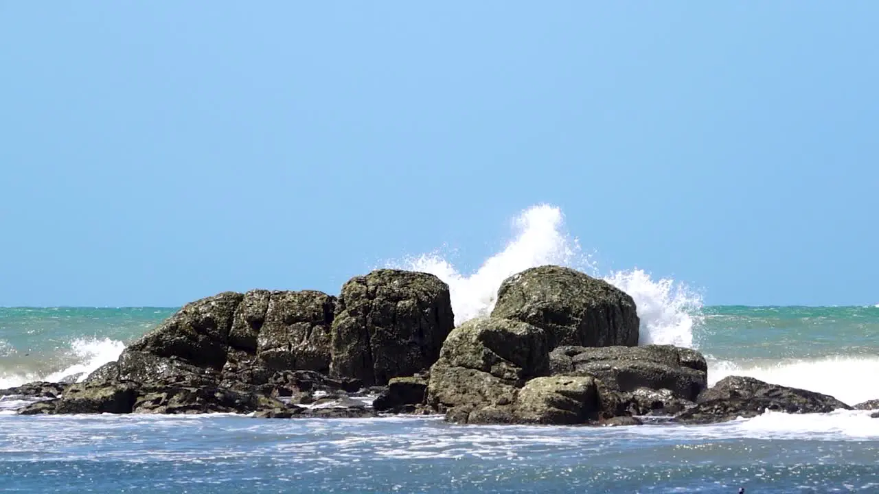 Waves crashing against rocks Patagonia Argentina slow motion wide shot