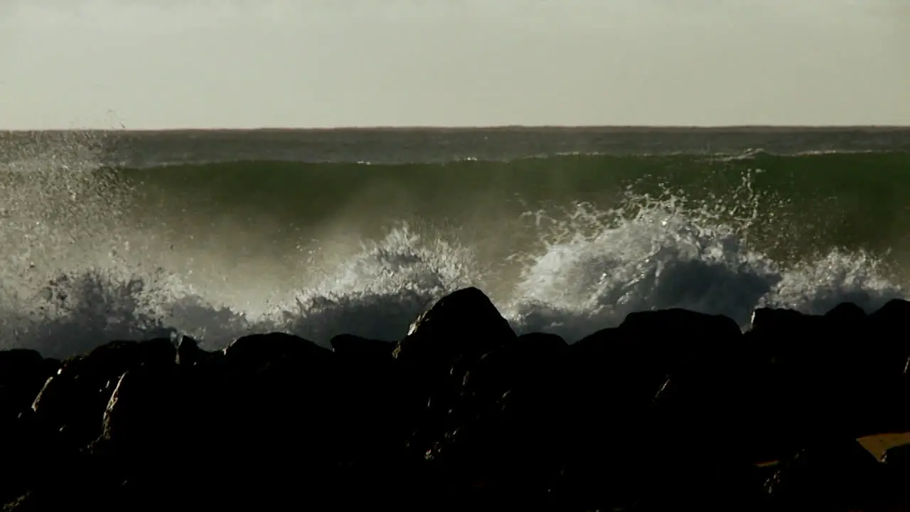 Large waves crest and break on a shoreline 1