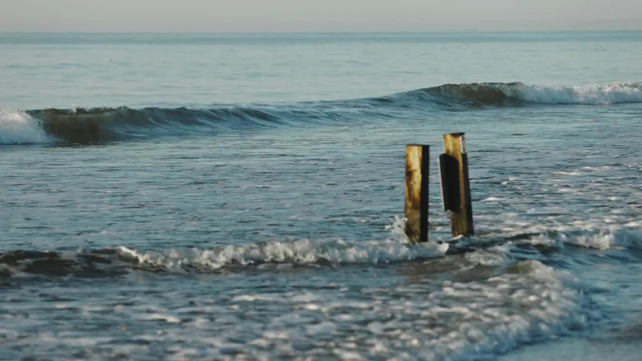 Slow motion shot of breaking waves of Atlantic Ocean reaching seashore during beautiful day