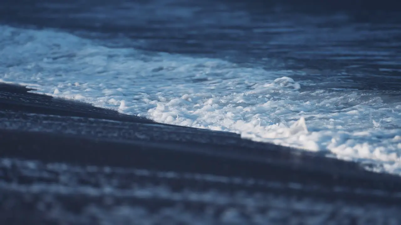 Waves break around the sandy beach