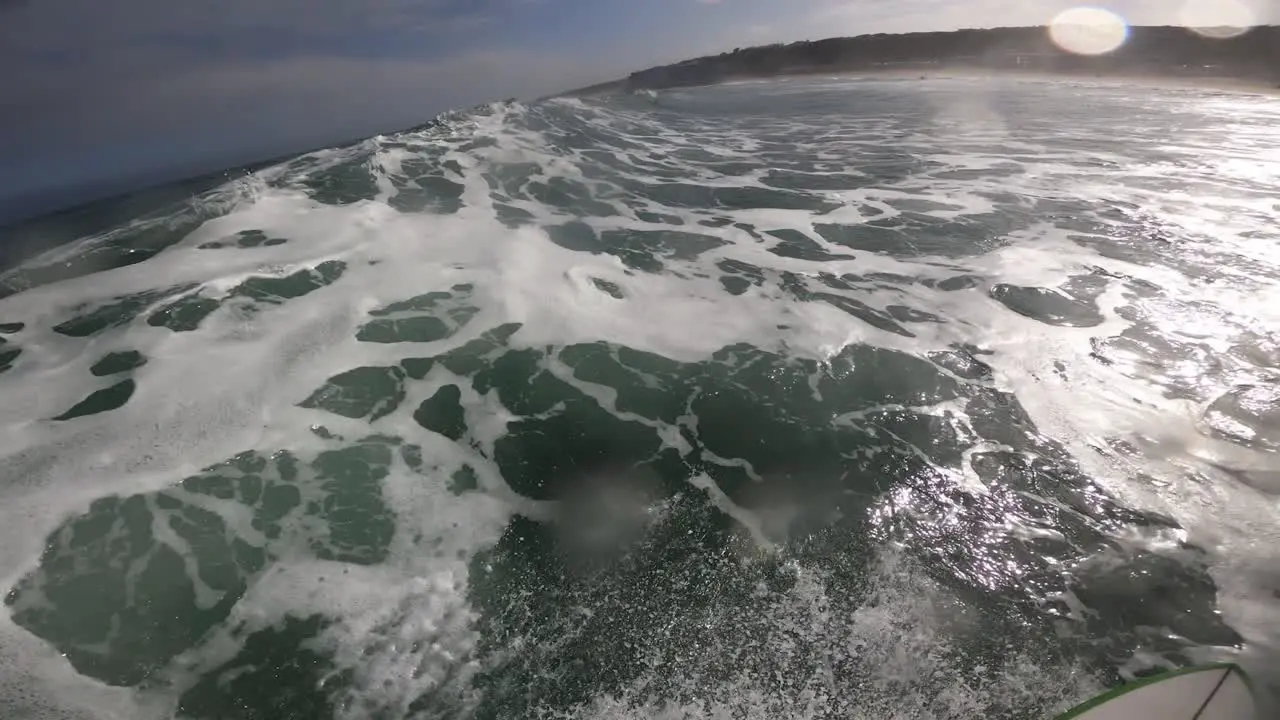 Young surfer ripping in perfect waves in Praia Grande Sintra