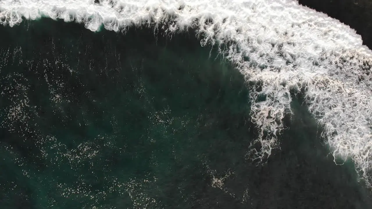 Aerial view of big waves coming from the ocean in Uluwatu Bali