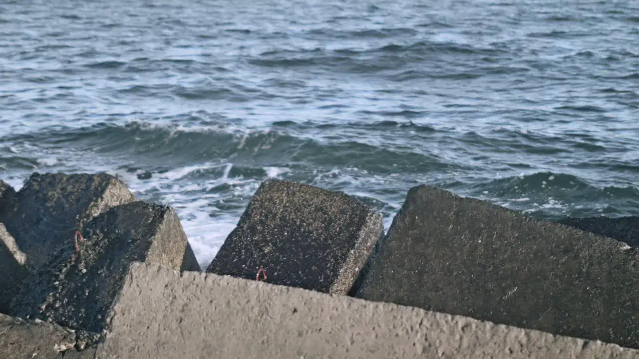 Concrete breakwaters Water splash on pier rock Sea waves crashing on rock