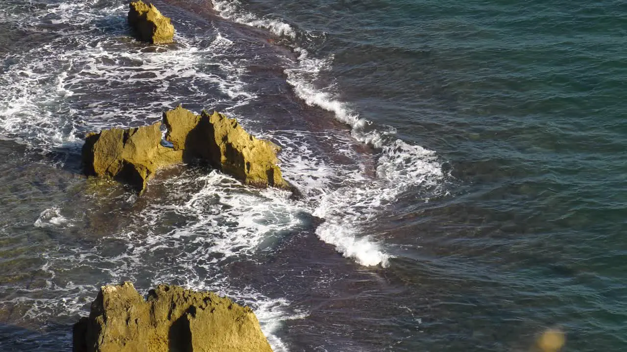 Ocean waves breaking on rocky reef high angle