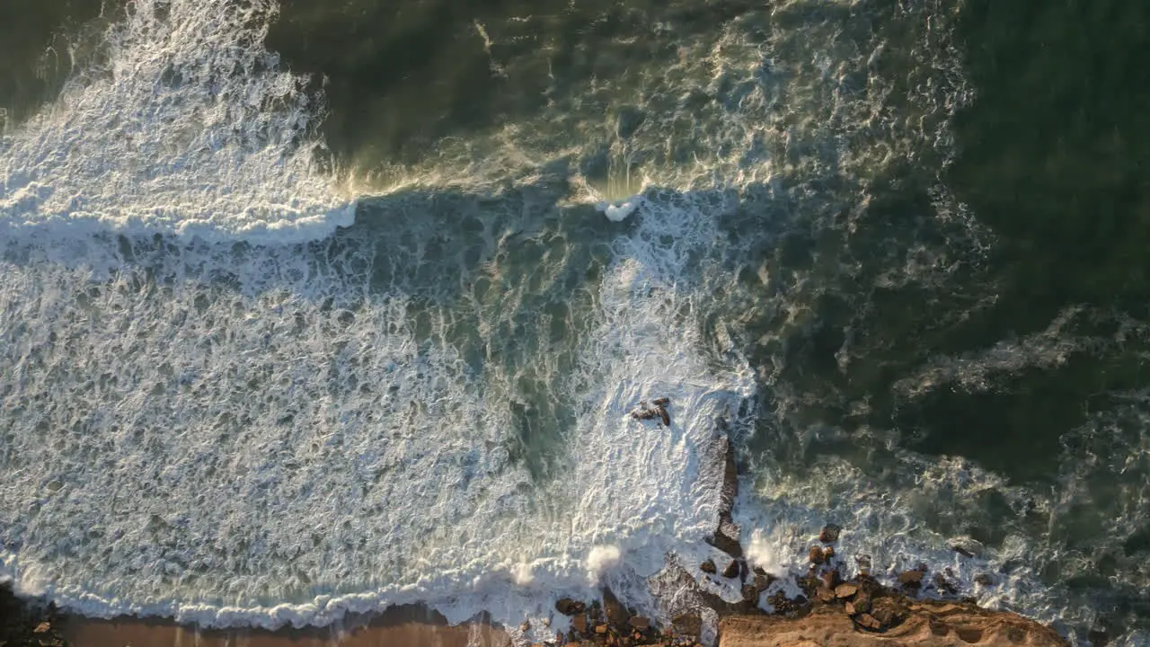 Panning shot of waves breaking at Ericeira in Portugal