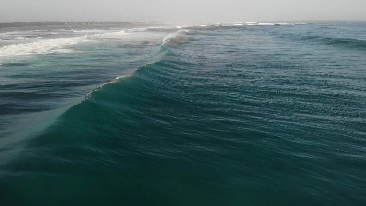 Cinematic Closeup Shot Of Tidal Ocean Waves Rolling On Foamy Surface