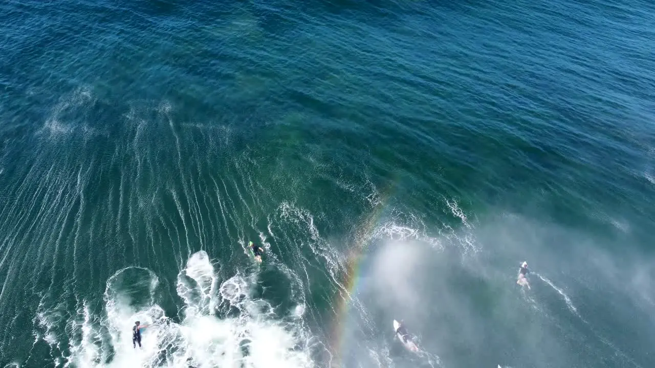 Drone aerial shot of surfers duck diving big wave in Pacific Ocean Wamberal Central Coast NSW Australia 3840x2160 4K