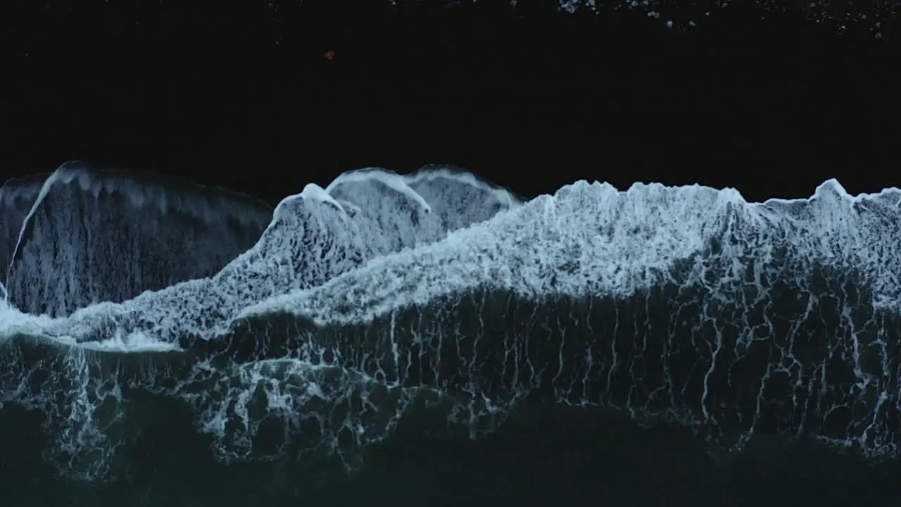 Beautiful Atlantic waves rolling on the black beach -top view