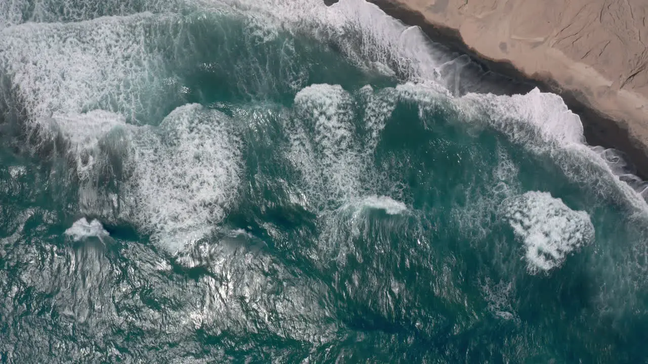 Aerial Big waves in Vlychada beach of Santorini Greece 4K prores