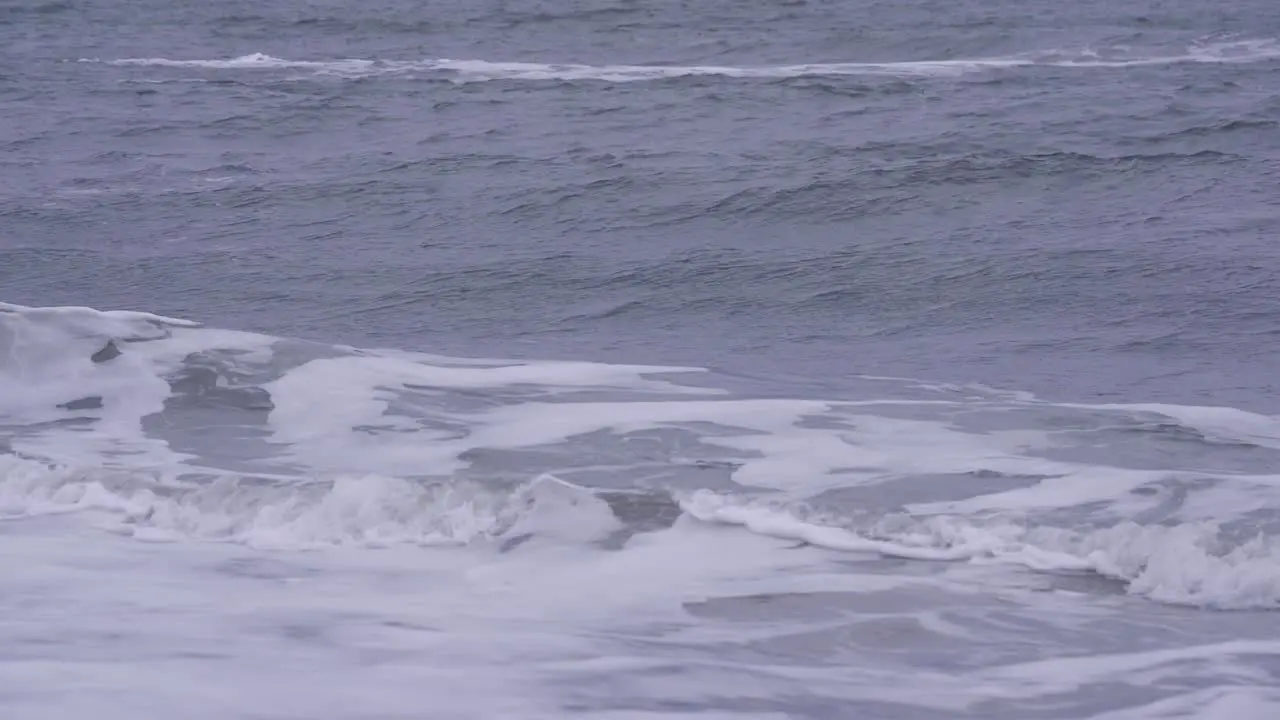 Rough Stormy Ocean Waves Rolling And Crashing Onto Beach Shoreline