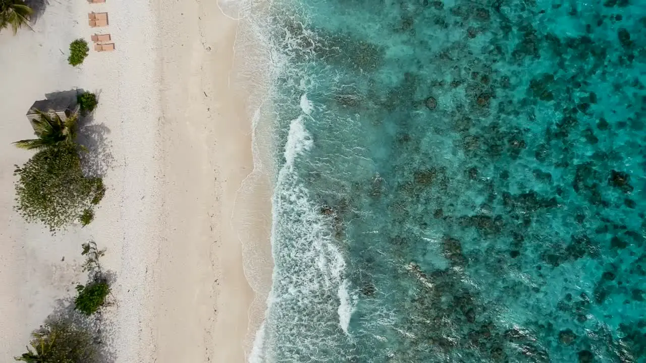 Drone footage of crystal clear blue water and waves on the shore of beach in Cebu Philippines-5