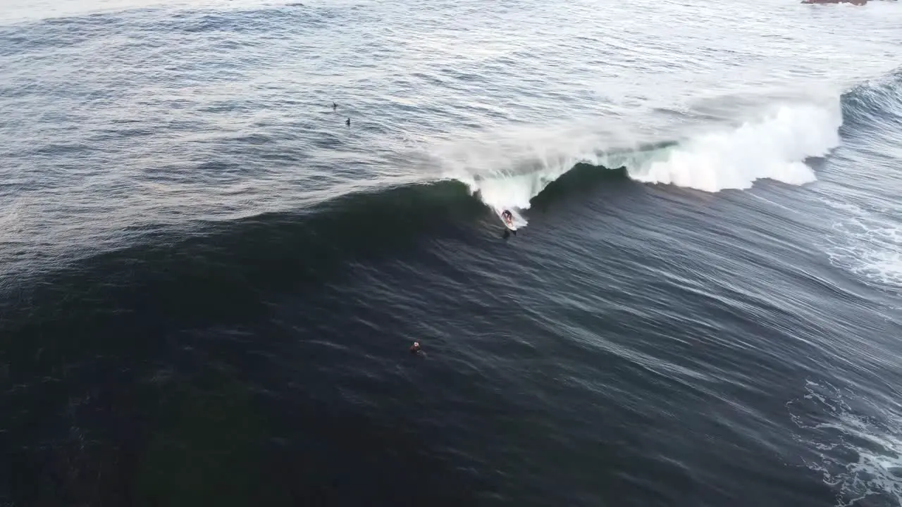 Drone pan aerial videography shot of surfer catching wave reef barrel Central Coast NSW Australia 3840x2160 4K