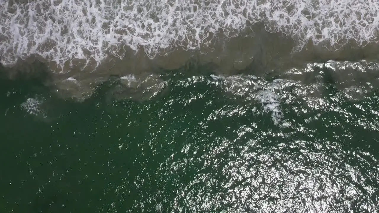 Topdown Of Emerald Ocean With Foamy Waves At Summertime