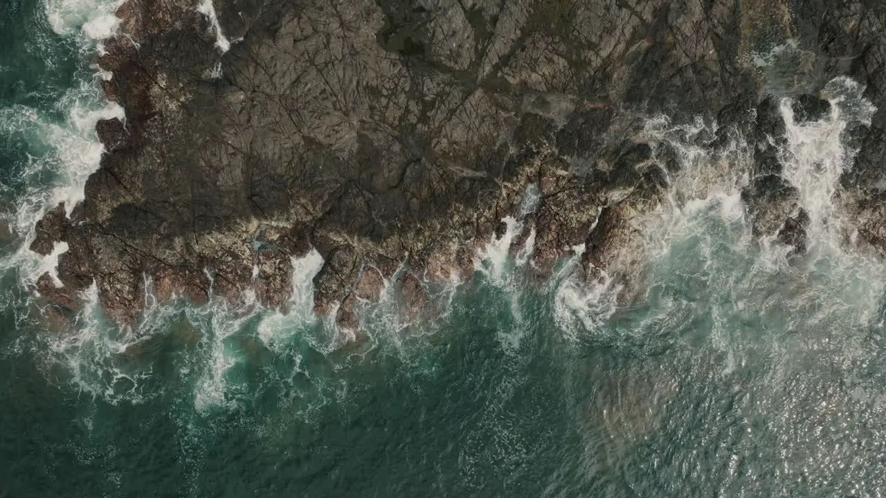 Top down View Of Ocean Waves Crashing On Rocky Shore Of Beach In Guanacaste Costa Rica aerial drone shot