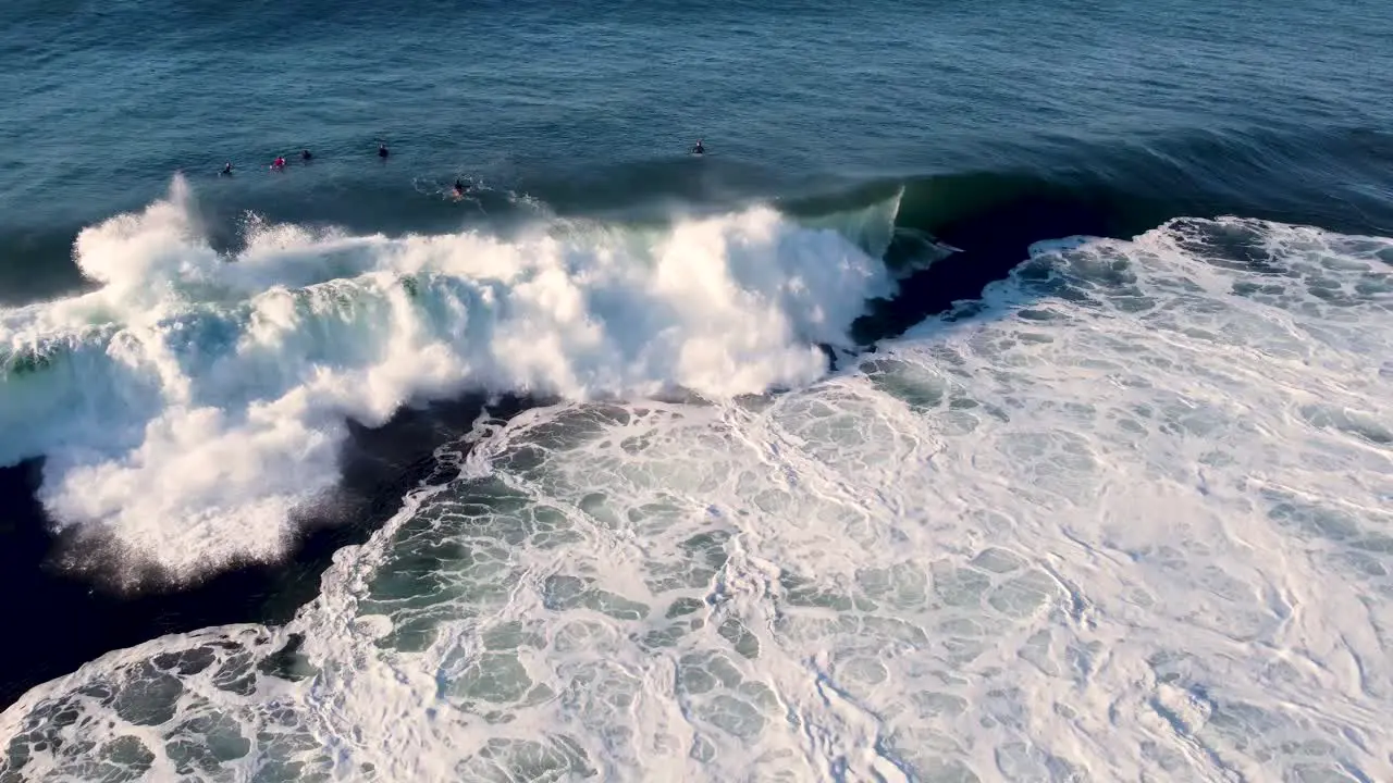 Drone aerial scenic shot of surfer riding left hand wave on reef Central Coast NSW Australia 3840x2160 4K