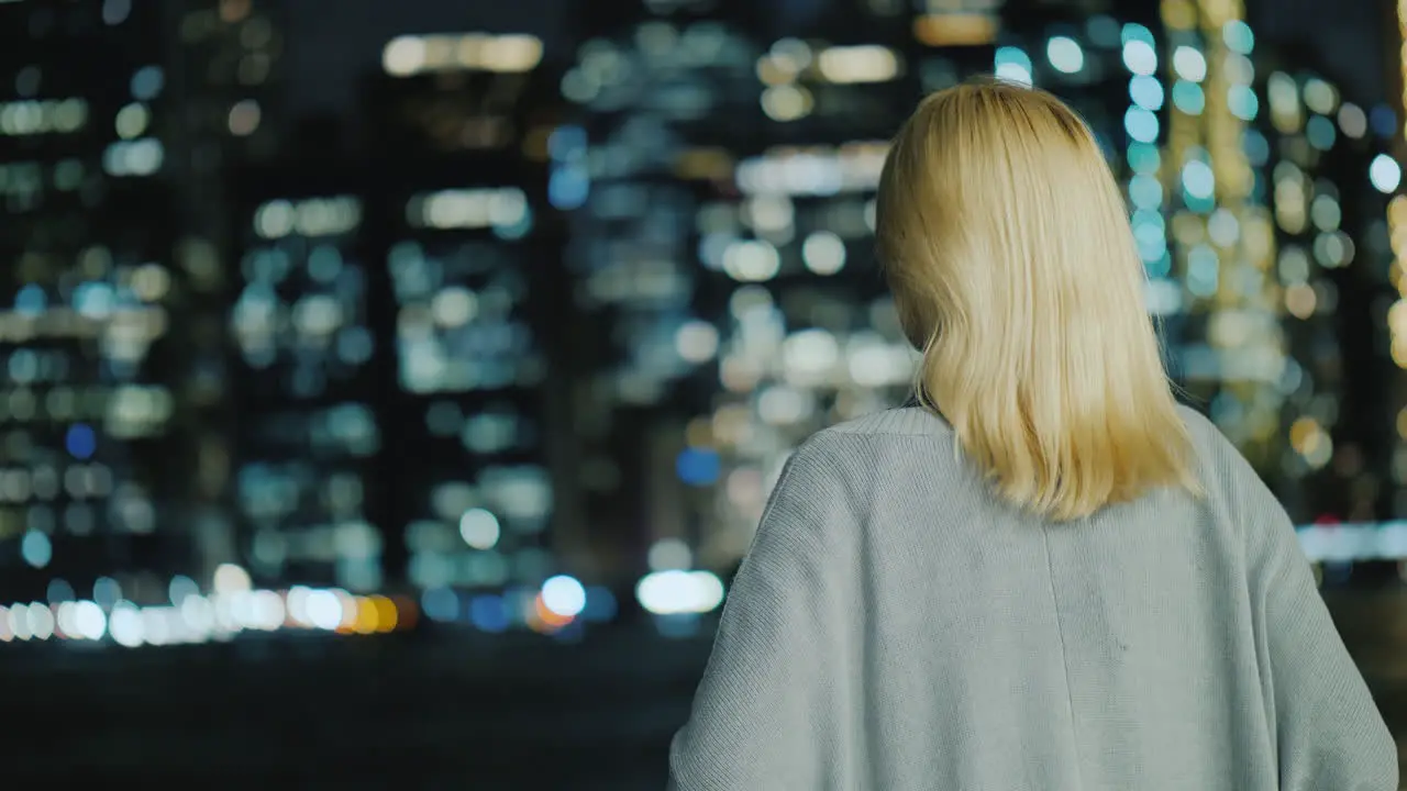 Blonde Woman Looking At The Night City Rear View