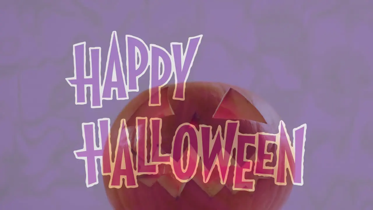 Animation of happy halloween text over carved pumpkin