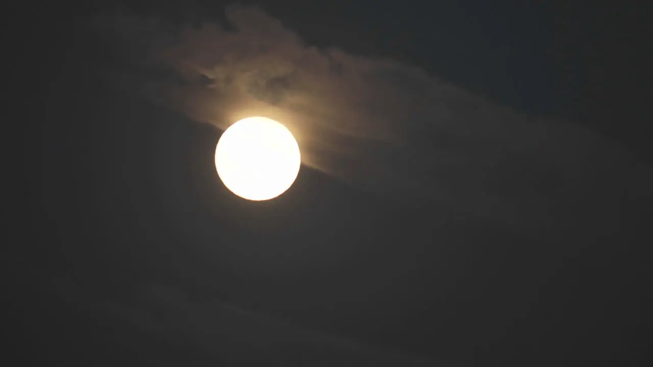 Time lapse of full moon rising out of the clouds in Oak View California